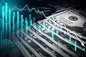 A close up of US currency overlaid with charts and graphs