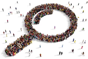 A large group of people arranged in the shape of a magnifying glass